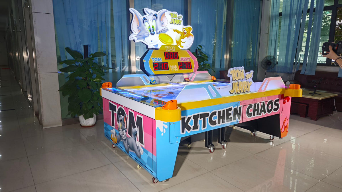 Tom & Jerry Kitchen Chaos air hockey table with multi-puck arcade action and cartoon-themed LED cabinet.