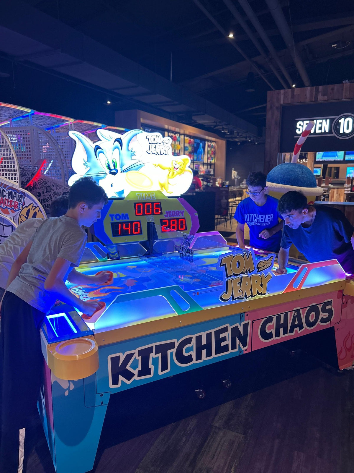 Tom & Jerry Kitchen Chaos air hockey table with multi-puck arcade action and cartoon-themed LED cabinet.