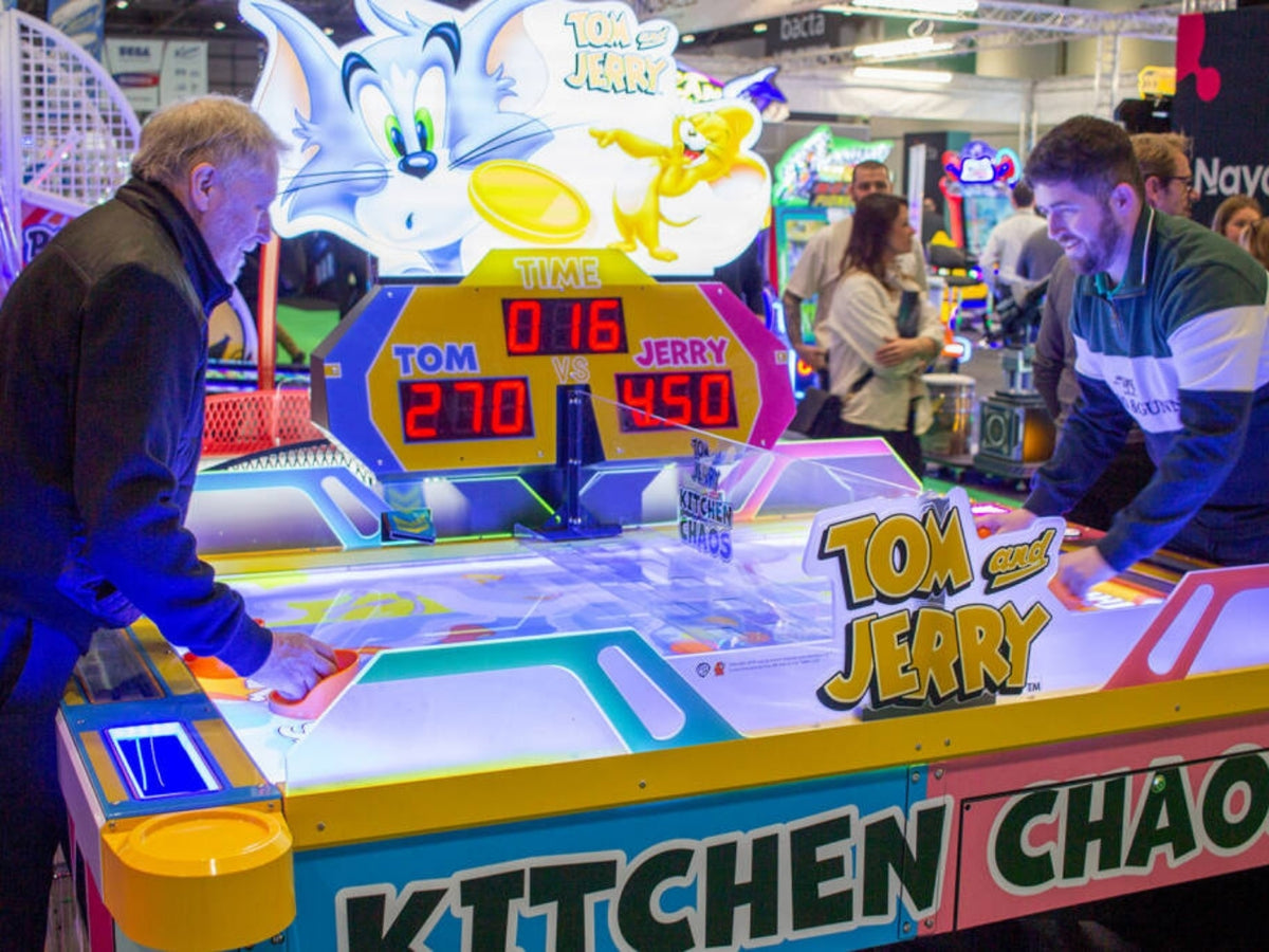 Tom & Jerry Kitchen Chaos air hockey table with multi-puck arcade action and cartoon-themed LED cabinet.