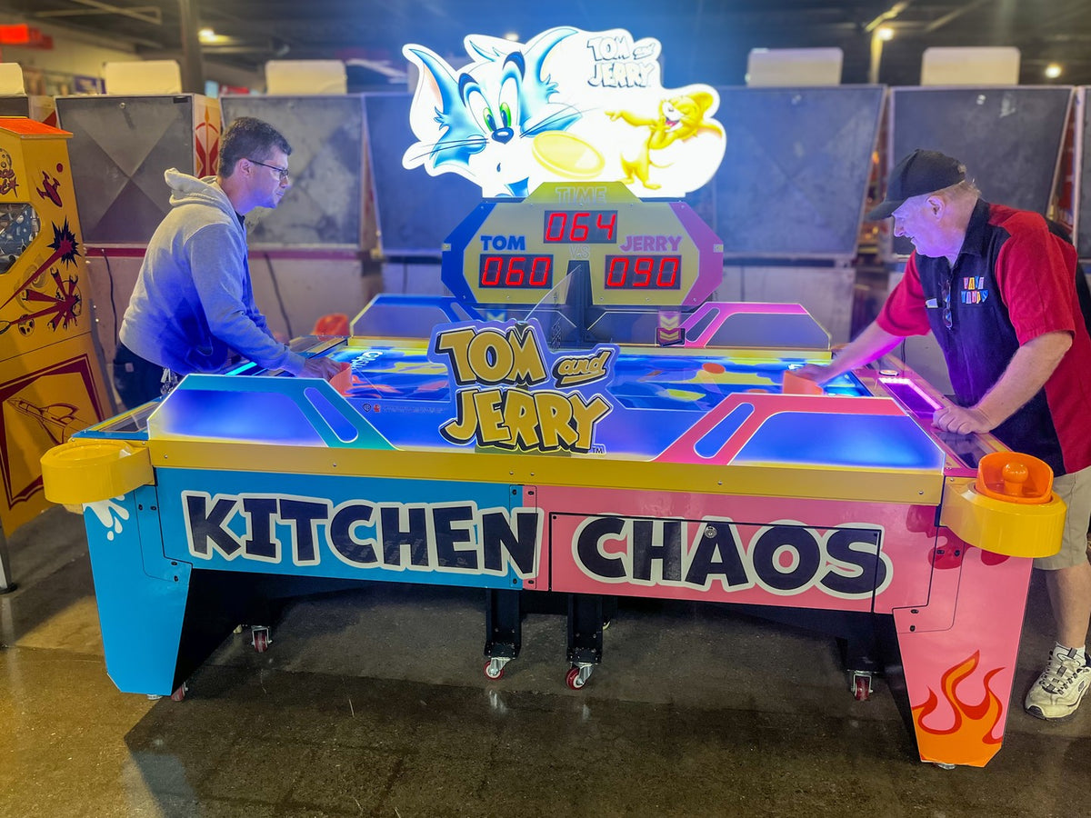 Tom & Jerry Kitchen Chaos air hockey table with multi-puck arcade action and cartoon-themed LED cabinet.