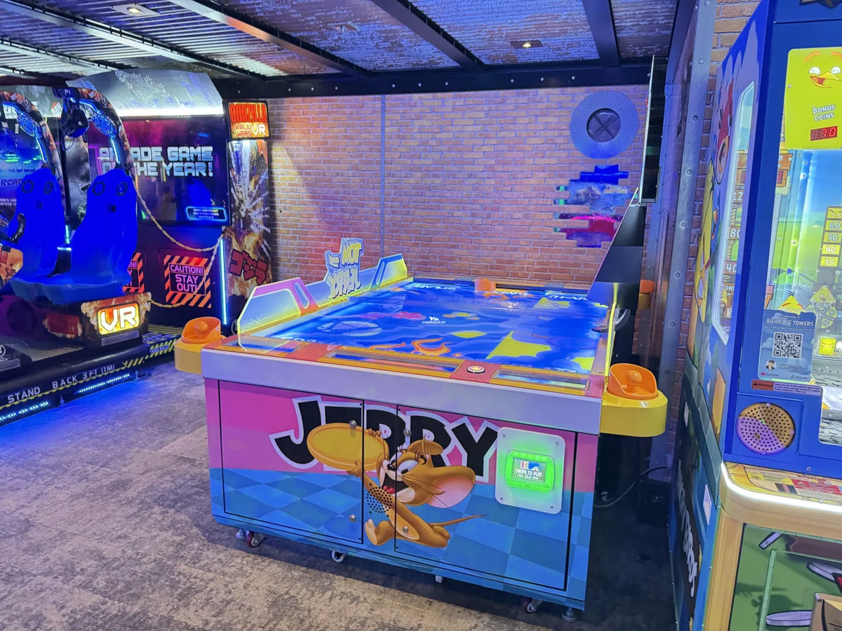 Tom & Jerry Kitchen Chaos air hockey table with multi-puck arcade action and cartoon-themed LED cabinet.